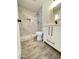 Modern bathroom with gray tile shower and white vanity at 6131 N 36Th Dr, Phoenix, AZ 85019