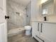 Updated bathroom, featuring a gray tile shower and white vanity at 6131 N 36Th Dr, Phoenix, AZ 85019