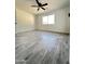 Spacious bedroom with wood-look tile floors and large window at 6131 N 36Th Dr, Phoenix, AZ 85019