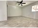 Spacious bedroom featuring wood-look tile floors and a ceiling fan at 6131 N 36Th Dr, Phoenix, AZ 85019