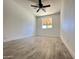 Bright bedroom with wood-look tile flooring and ceiling fan at 6131 N 36Th Dr, Phoenix, AZ 85019