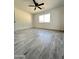 Bright bedroom featuring wood-look tile floors and ceiling fan at 6131 N 36Th Dr, Phoenix, AZ 85019