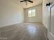 Spacious bedroom with wood-look tile floors and ceiling fan at 6131 N 36Th Dr, Phoenix, AZ 85019