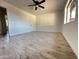 Light and airy bedroom with wood-look floors and ceiling fan at 6131 N 36Th Dr, Phoenix, AZ 85019