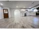 Modern kitchen with white cabinets, gray tile floors, and stainless steel appliances at 6131 N 36Th Dr, Phoenix, AZ 85019