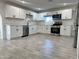 Modern kitchen featuring white shaker cabinets, stainless steel appliances, and quartz countertops at 6131 N 36Th Dr, Phoenix, AZ 85019