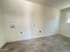 Bright laundry room with gray tile floor and hookups for washer/dryer at 6131 N 36Th Dr, Phoenix, AZ 85019