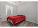 Bedroom with red bedding and plantation shutters at 6608 N Cima Vista Dr, Casa Grande, AZ 85194