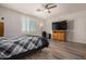 Bright bedroom featuring wood-look floors and plantation shutters at 6608 N Cima Vista Dr, Casa Grande, AZ 85194