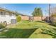 Backyard view showcasing grassy lawn and AC unit at 6627 N 16Th Dr, Phoenix, AZ 85015