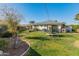 Large backyard featuring a grassy area, trampoline, and playset at 6627 N 16Th Dr, Phoenix, AZ 85015