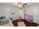 Charming bedroom with a crib and toy kitchen at 6627 N 16Th Dr, Phoenix, AZ 85015