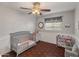 Well-lit bedroom featuring a crib and storage at 6627 N 16Th Dr, Phoenix, AZ 85015