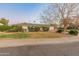 Ranch style home with grassy front yard and mature trees at 6627 N 16Th Dr, Phoenix, AZ 85015