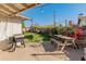 Backyard patio with wooden picnic table and grill at 6627 N 16Th Dr, Phoenix, AZ 85015