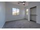 Well-lit bedroom with carpet, window, and closet at 6909 N 71St Dr, Glendale, AZ 85303