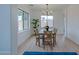 Bright dining room with hardwood floors, modern chandelier, and a large window at 6909 N 71St Dr, Glendale, AZ 85303