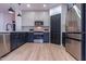 Modern kitchen with stainless steel appliances and white cabinets at 6909 N 71St Dr, Glendale, AZ 85303