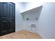 Simple laundry room with wood-look floors and built-in shelving at 6909 N 71St Dr, Glendale, AZ 85303