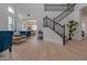 Bright living room with high ceilings, hardwood floors, and stylish blue velvet furniture at 6909 N 71St Dr, Glendale, AZ 85303