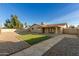 Landscaped backyard with artificial turf and stone pathway at 7118 E Arbor Ave, Mesa, AZ 85208