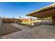 Covered patio and backyard with stone pathway at 7118 E Arbor Ave, Mesa, AZ 85208