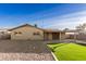 Backyard view showing home's exterior and grassy area at 7118 E Arbor Ave, Mesa, AZ 85208