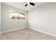 Well-lit bedroom featuring a ceiling fan and carpet at 7118 E Arbor Ave, Mesa, AZ 85208