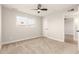 Bedroom with ceiling fan, window, and neutral carpeting at 7118 E Arbor Ave, Mesa, AZ 85208