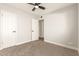 Spacious bedroom with ceiling fan and doors to hallway at 7118 E Arbor Ave, Mesa, AZ 85208