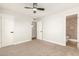 Bedroom with ceiling fan, neutral carpeting and en-suite bath at 7118 E Arbor Ave, Mesa, AZ 85208