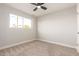 Bright bedroom with ceiling fan and neutral carpeting at 7118 E Arbor Ave, Mesa, AZ 85208