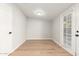 Laundry room with French doors and wood-look flooring at 7118 E Arbor Ave, Mesa, AZ 85208