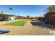 Spacious backyard with artificial turf, gravel, shed, and patio furniture at 7217 W Claremont St, Glendale, AZ 85303