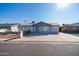 Single story home with gray exterior, landscaping, and driveway at 7217 W Claremont St, Glendale, AZ 85303