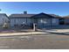 Gray single story home with landscaped front yard and a covered porch at 7217 W Claremont St, Glendale, AZ 85303