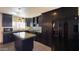 Modern kitchen with dark cabinetry and concrete island at 7217 W Claremont St, Glendale, AZ 85303