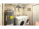 Bright laundry room, washer, dryer, and water heater at 7217 W Claremont St, Glendale, AZ 85303