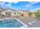 Relaxing backyard with a sparkling pool, patio furniture, and drought-tolerant landscaping at 8043 E Jaeger St, Mesa, AZ 85207