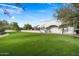 Large grassy backyard with mature trees and stunning views at 8515 E Sutton Dr, Scottsdale, AZ 85260