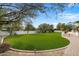 Landscaped backyard featuring a large lawn and curved walkway at 8515 E Sutton Dr, Scottsdale, AZ 85260