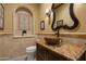 Spa-like bathroom with a unique vessel sink, marble vanity, and decorative tile at 8515 E Sutton Dr, Scottsdale, AZ 85260