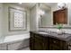 Spa-like bathroom with light green subway tiles and a soaking tub at 8515 E Sutton Dr, Scottsdale, AZ 85260