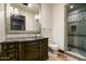 Bathroom with dark wood vanity and a glass-enclosed shower at 8515 E Sutton Dr, Scottsdale, AZ 85260