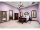 Serene bedroom with a lavender wall and a dark wood bed frame at 8515 E Sutton Dr, Scottsdale, AZ 85260