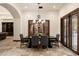 Elegant dining area features a dark wood table, striped chairs, and a chandelier at 8515 E Sutton Dr, Scottsdale, AZ 85260