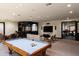 Game room features a pool table, a home bar, and views into a home gym at 8515 E Sutton Dr, Scottsdale, AZ 85260