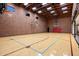 Spacious indoor basketball court with two hoops and hardwood flooring at 8515 E Sutton Dr, Scottsdale, AZ 85260