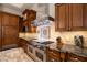 Kitchen features a professional range, custom cabinetry, and granite countertops at 8515 E Sutton Dr, Scottsdale, AZ 85260