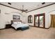 Bright main bedroom with access to the backyard patio at 8515 E Sutton Dr, Scottsdale, AZ 85260